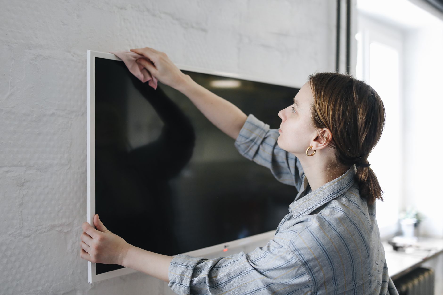 Essuyage d’un écran plat de télévision au chiffon doux